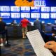 William Hill lowers profit forecast