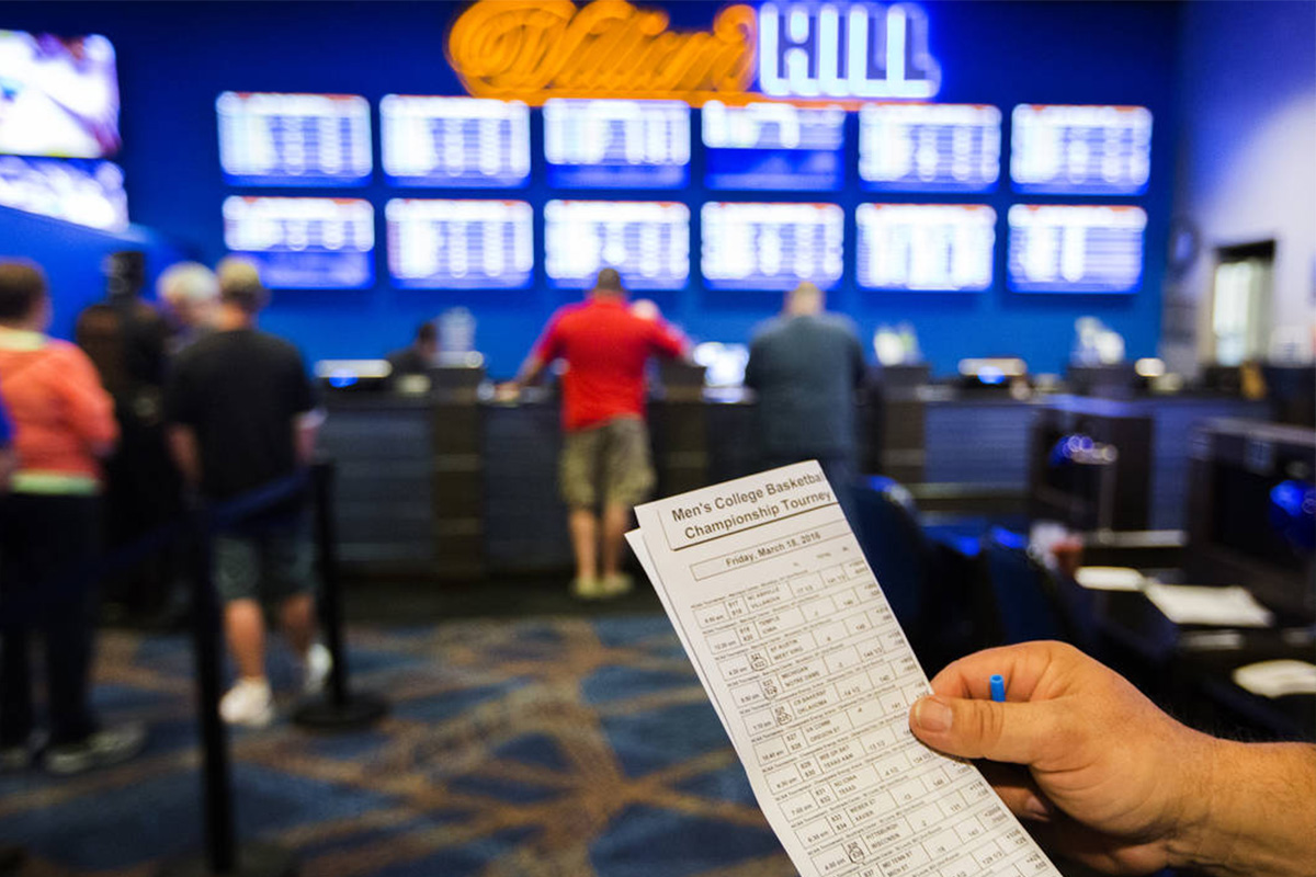 William Hill lowers profit forecast